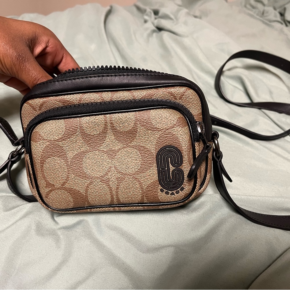 Brown Coach cross body purse.